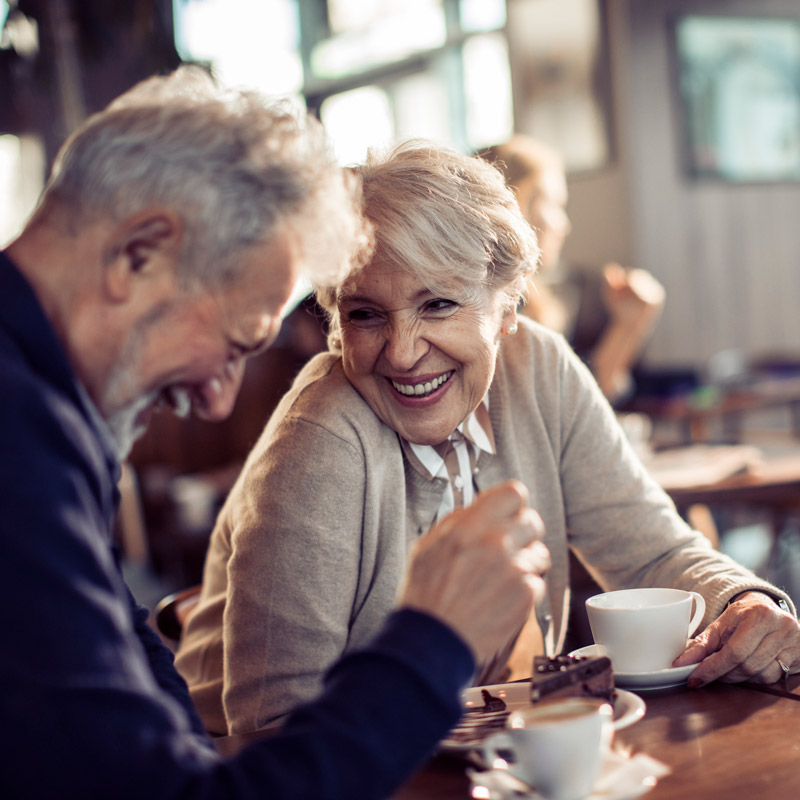 a couple laughing in a coffee shop